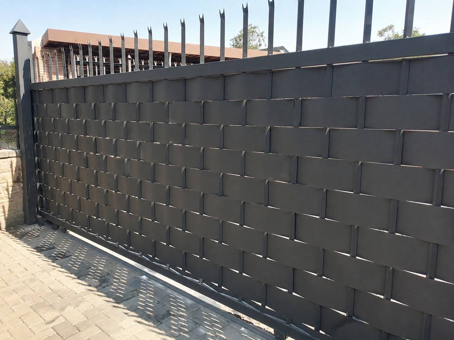 Woven pedestrian access gate in a boundary wall